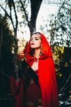 beautiful blonde woman wearing red cape