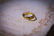 elegant gold wedding rings on invitation